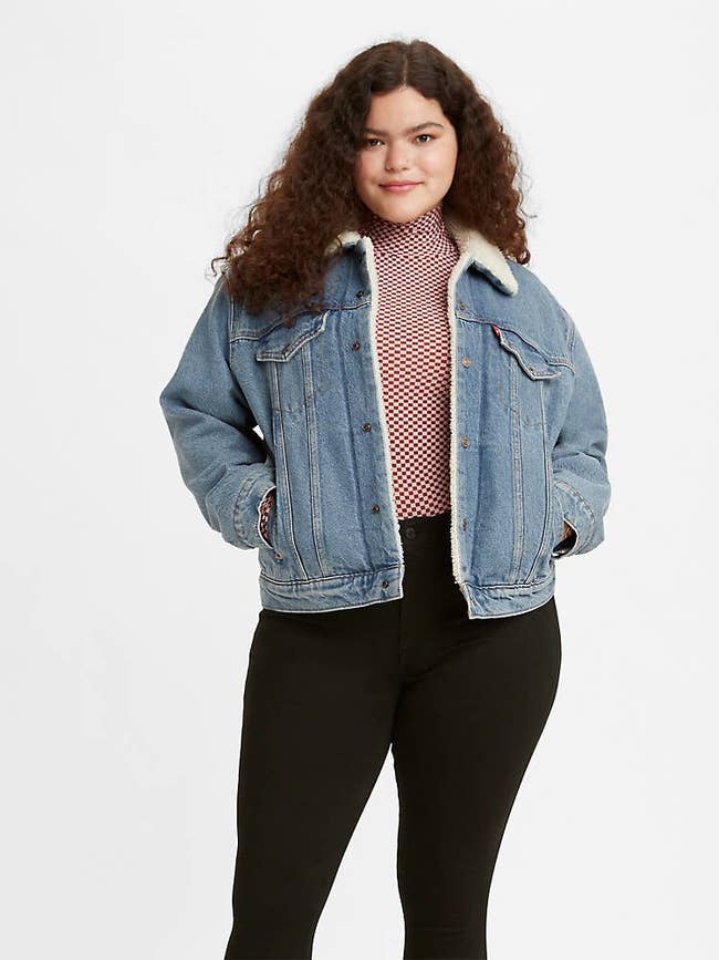 a model in a denim jacket lined with sherpa