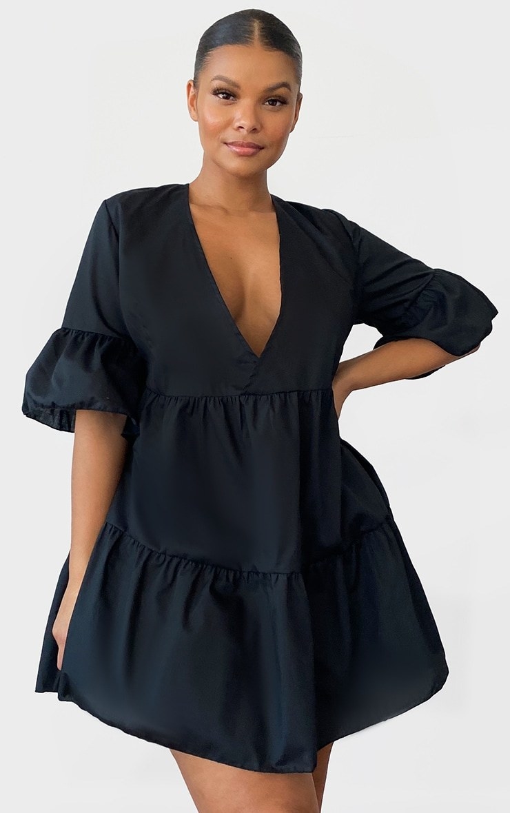 Model wearing black smock dress