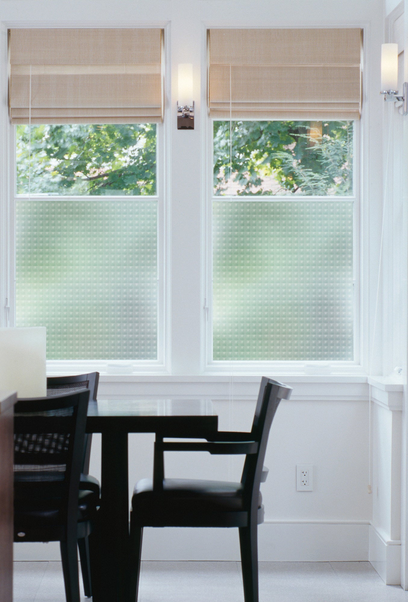 Double window with bottom part covered in peel and stick film.