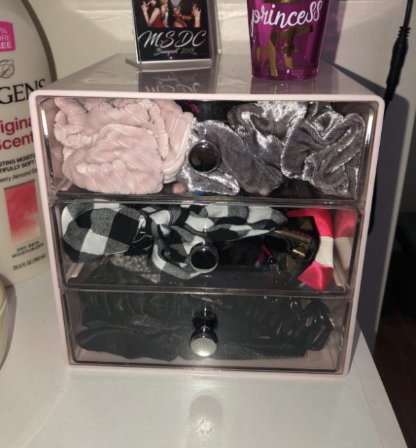 eyeglasses organizer with three drawers and scrunchies stored inside