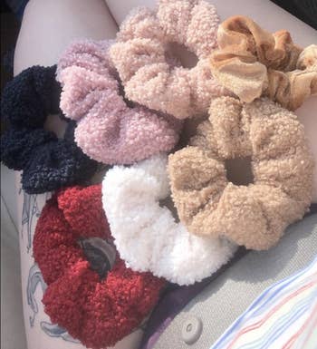 A set of six scrunchies in black, pink, ivory, beige, white, and red 