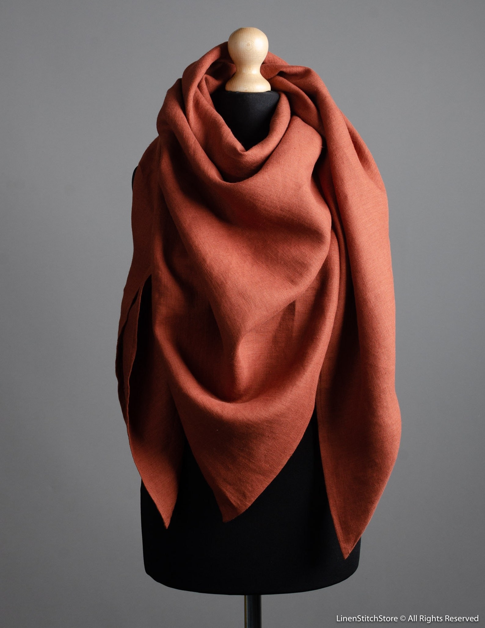 A chestnut brown shawl on a mannequin