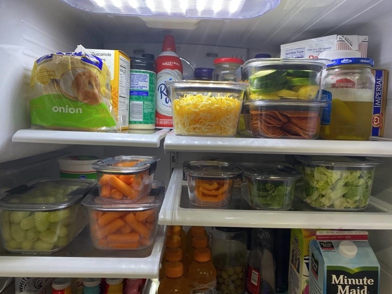 Plastic food storage containers in fridge with food inside