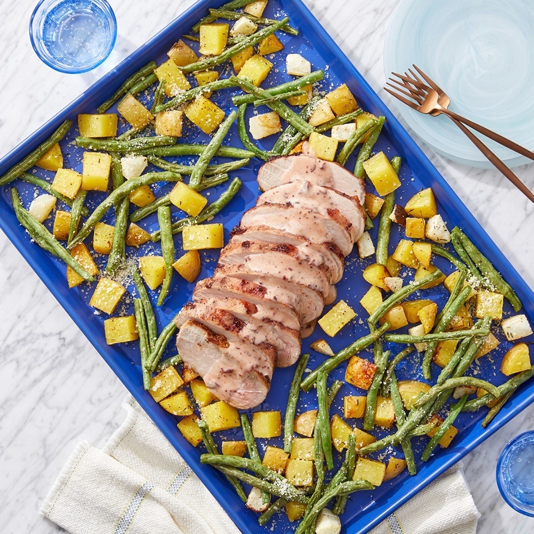 a photo of a meal that come from blue apron and the meal consists of a chicken breast with a sauce drizzled over it and green beans with roasted potatoes