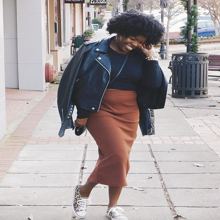 reviewer wearing the orange skirt