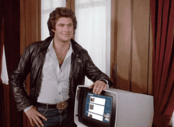David Hasselhoff pointing to an old computer that has a Tumblr dashboard photoshopped onto the screen