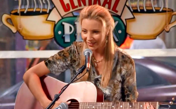 Lisa Kudrow as Phoebe Buffay playing a guitar
