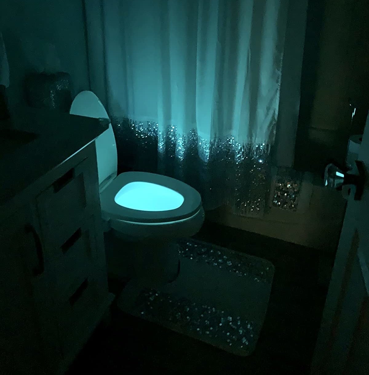 reviewer photo of a toilet lit up blue with the night light