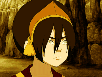 Toph blowing hair out of her face