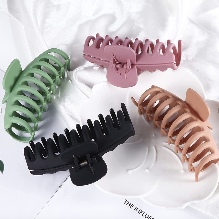 Claw clips in green, black, beige, and pink