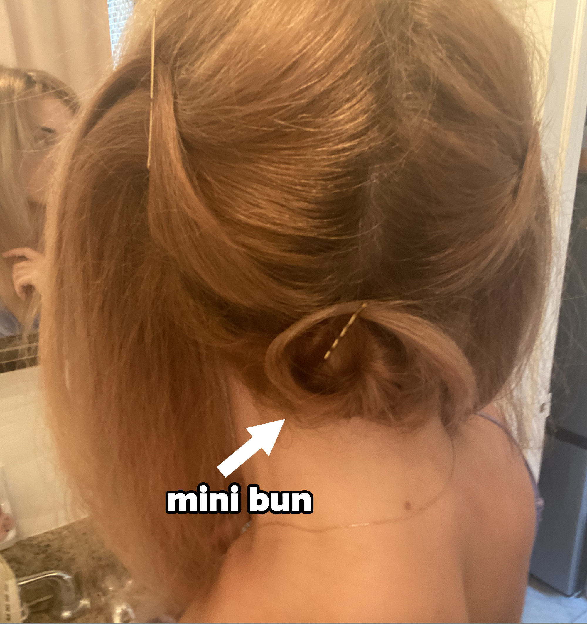 Me with the under-lengths of my hair in a mini bun