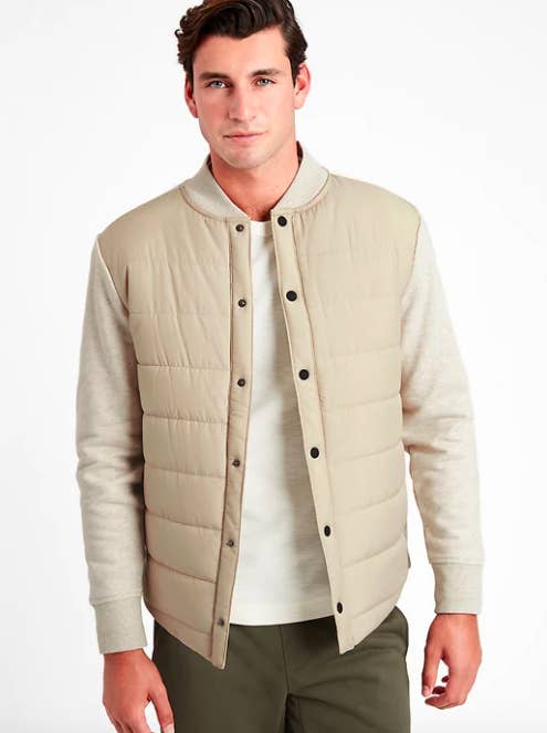 someone wearing the quilted jacket; it has knitted sleeves and a puffy torso