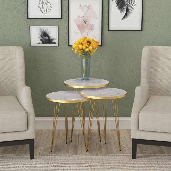 the nesting tables with white marble tops and golden legs