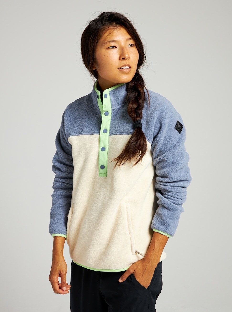 a model in a fleece pullover with a white middle and blue sleeves
