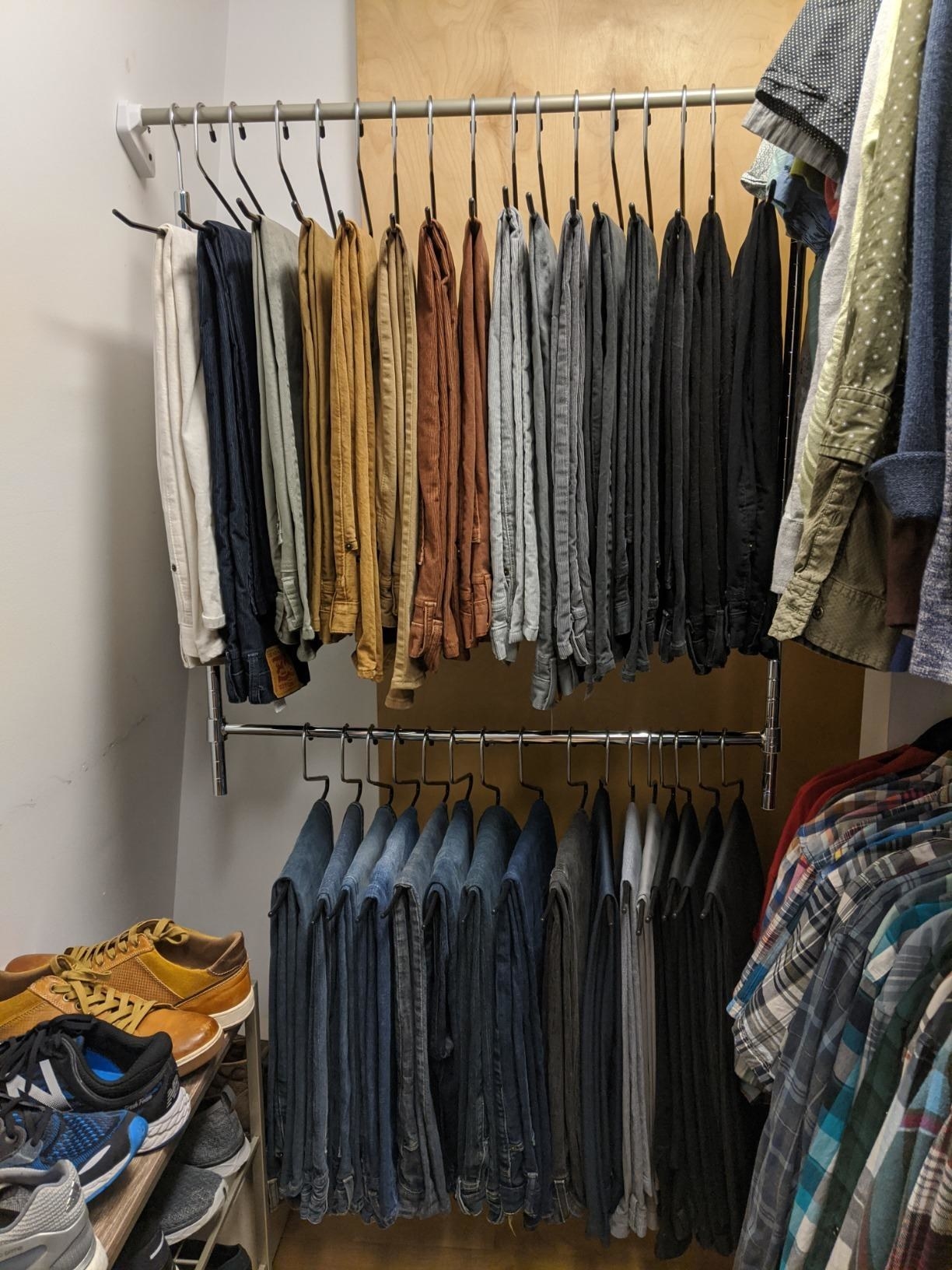 reviewer&#x27;s closet with silver rod hanging off permanent rod holding more clothes