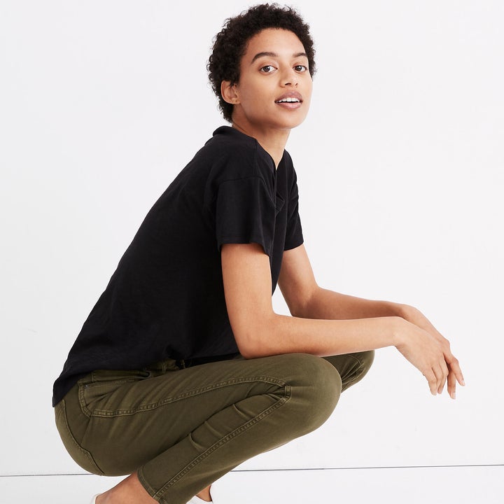 Model wearing black t-shirt and green pants