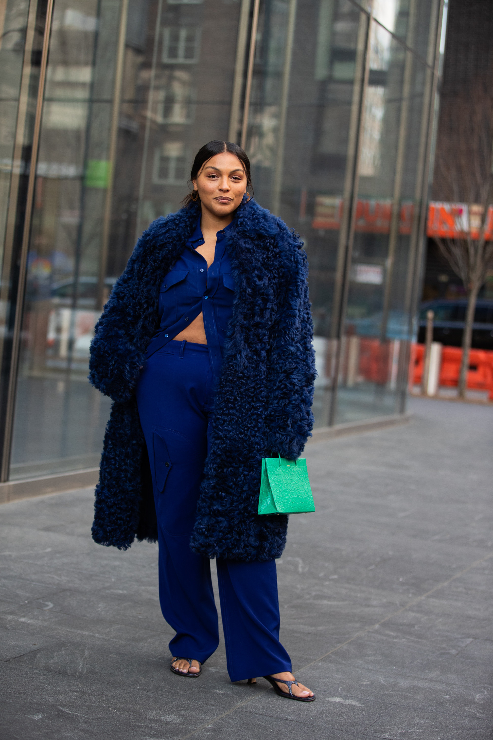 Paloma Elsesser in a blue suit and teddy bear style coat