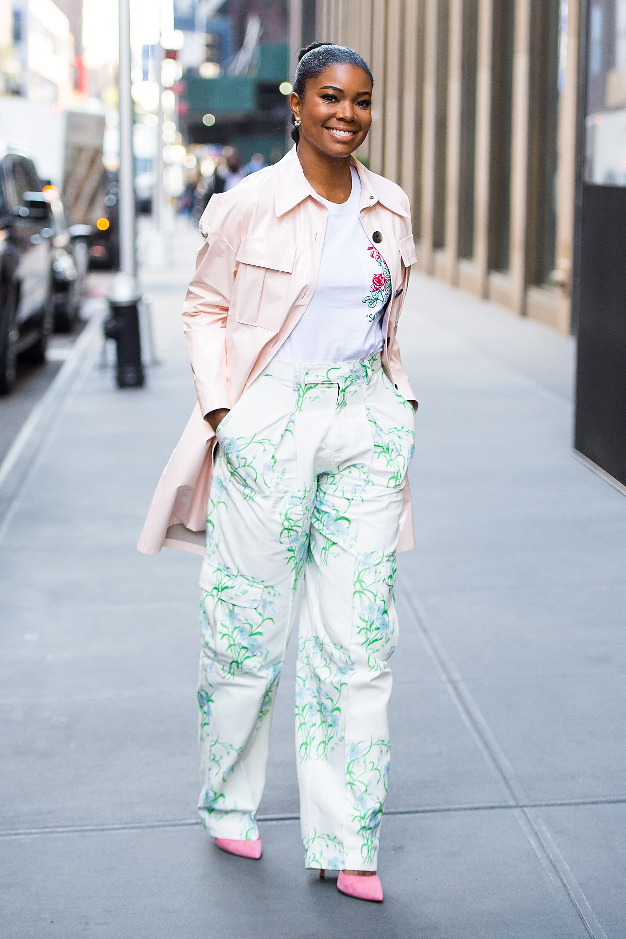 Gabrielle Union in a blush overcoat, green patterned pants and a floral embroidered t-shirt
