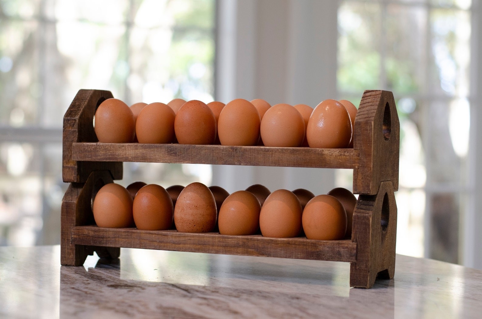 The egg tray stacked on top of another one with eggs on it