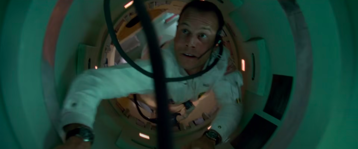 a crewmember floats up a tunnel to check the controls