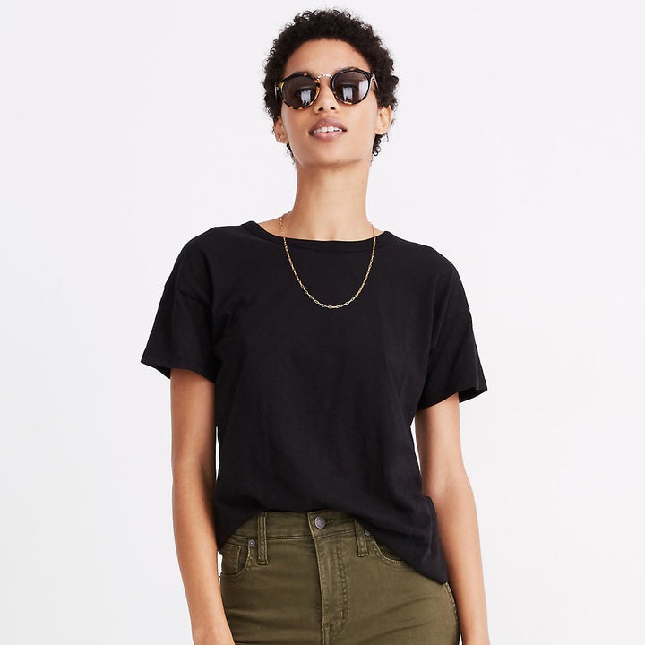 Model wearing black t-shirt and green pants