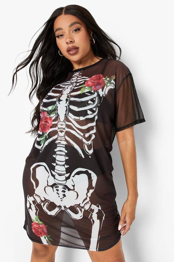 a plus size model wearing the skeleton rose dress