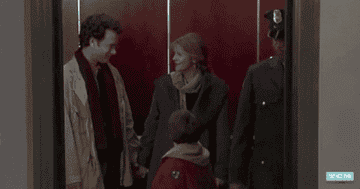 Gif from Sleepless in Seattle of an elevator closing with two main actors smiling at each other