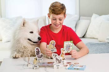 Child model and dog playing board game