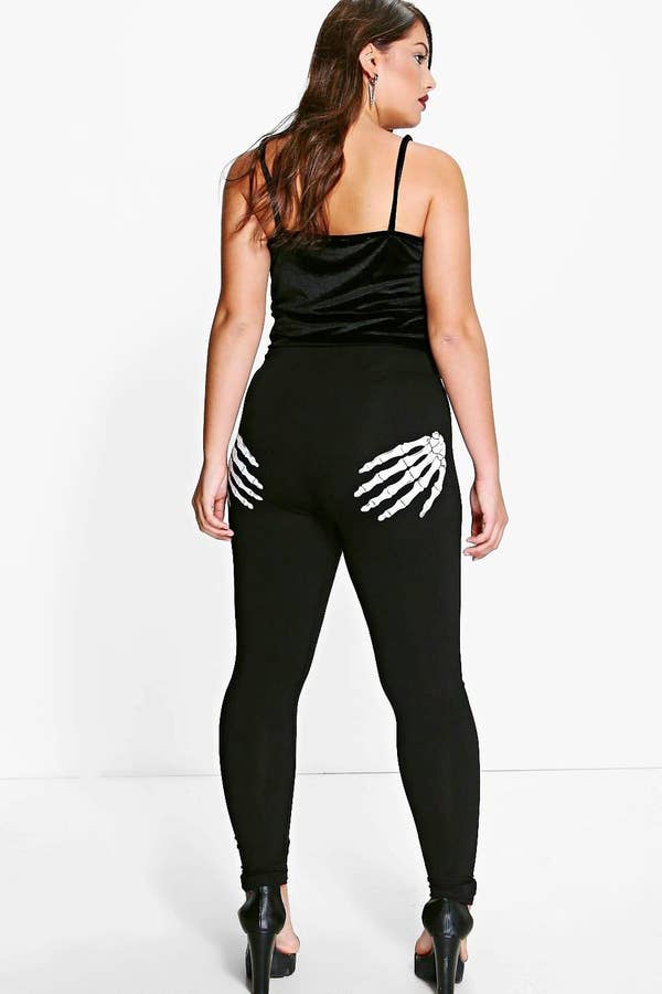 a plus size model wearing the skeleton hands leggings