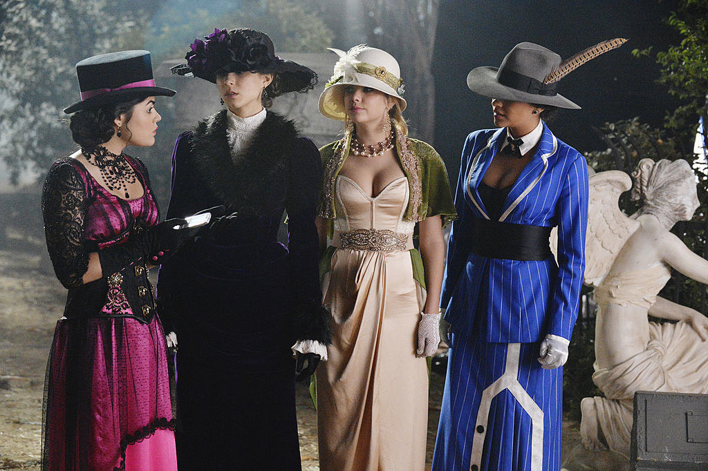 all four girls wearing Edwardian-style ball gowns with intricate details