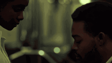 Gif of actor kissing love interests hand in If Beale Street Could Talk