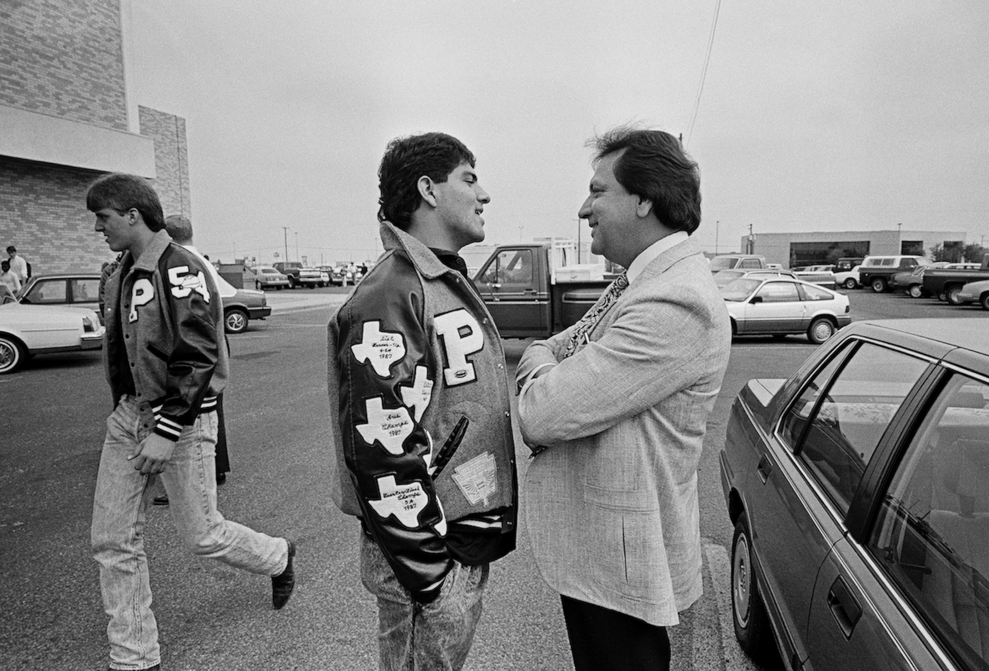 Young man and older man stand looking at each other