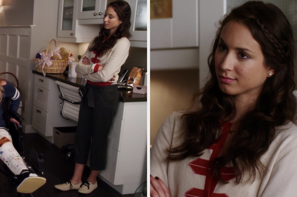Spencer wearing a sweater with red trim and loafers