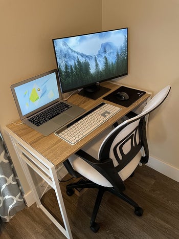 reviewer uses same ergonomic chair in a white shade for their wood desk setup
