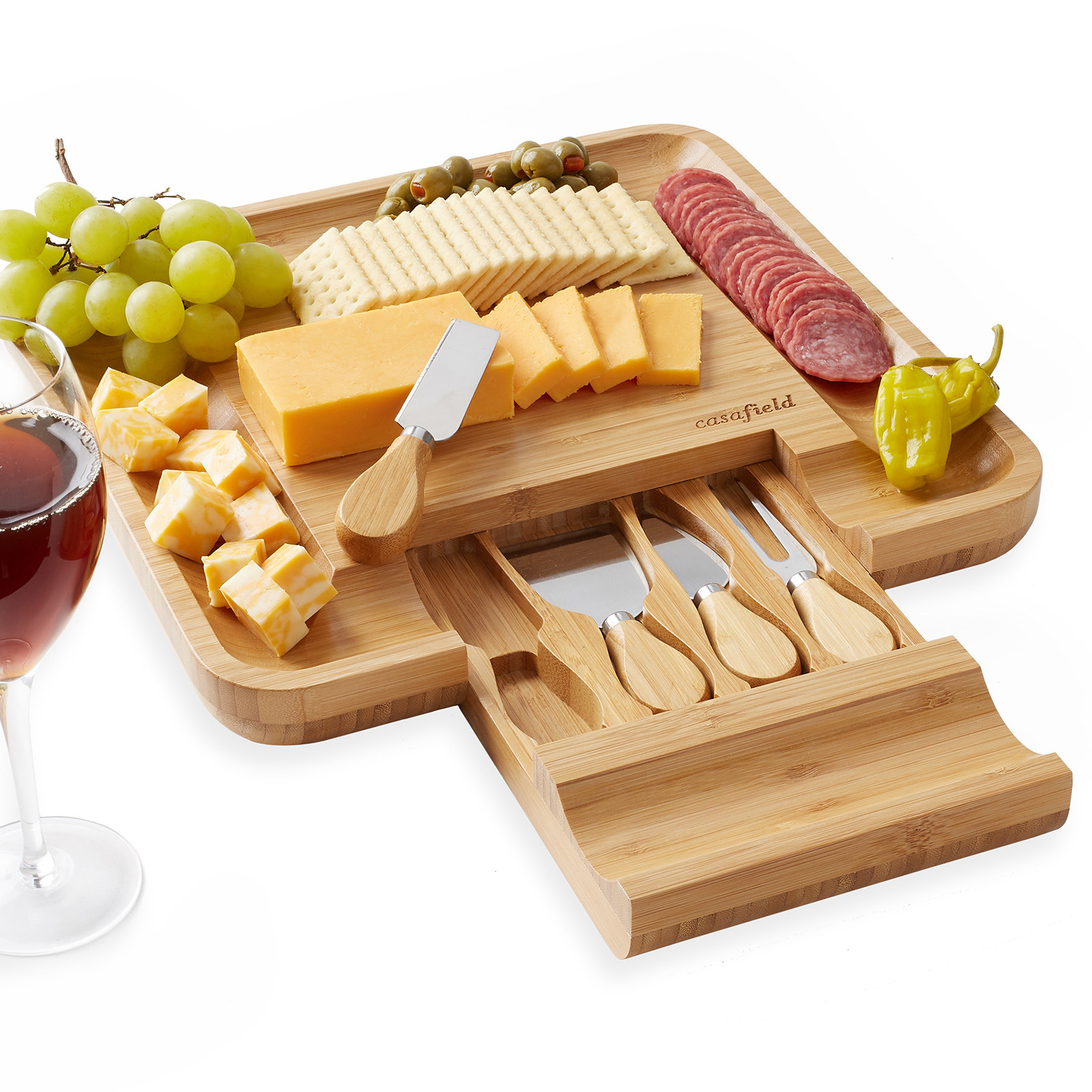 Bamboo tray and knife set shown with food and a wine glass next to it.