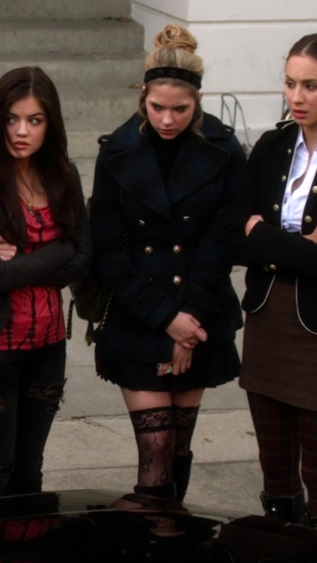 Hanna wearing laced stockings and a blue peacoat with a matching headband