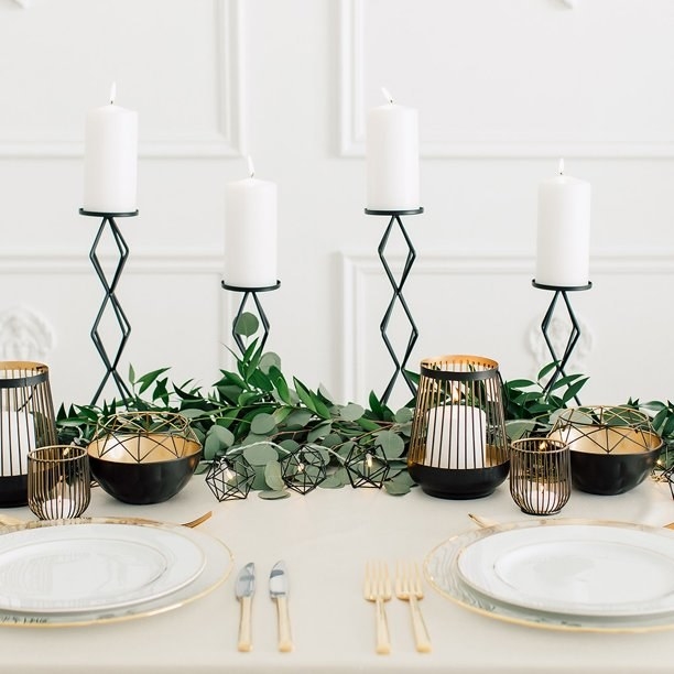 Four of the candle holders used as part of a table centerpiece.