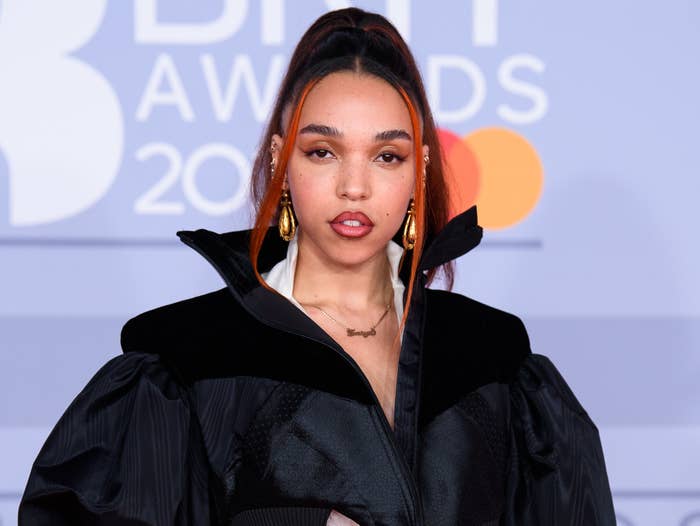 FKA twigs poses at an event