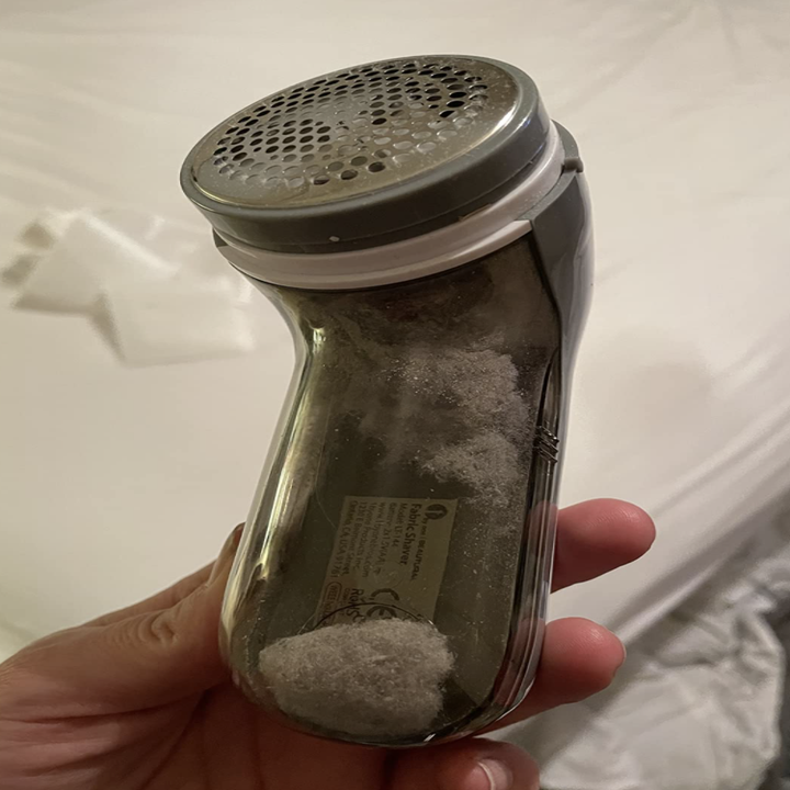 a reviewer holding the fabric shaver