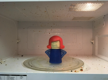 microwave covered in food debris