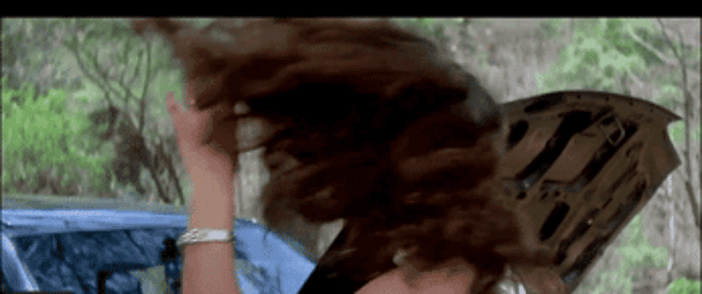 GIF showing Juhi Chawla flipping her hair and removing her sunglasses