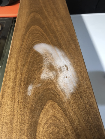 a white watermark on a reviewer's wooden table