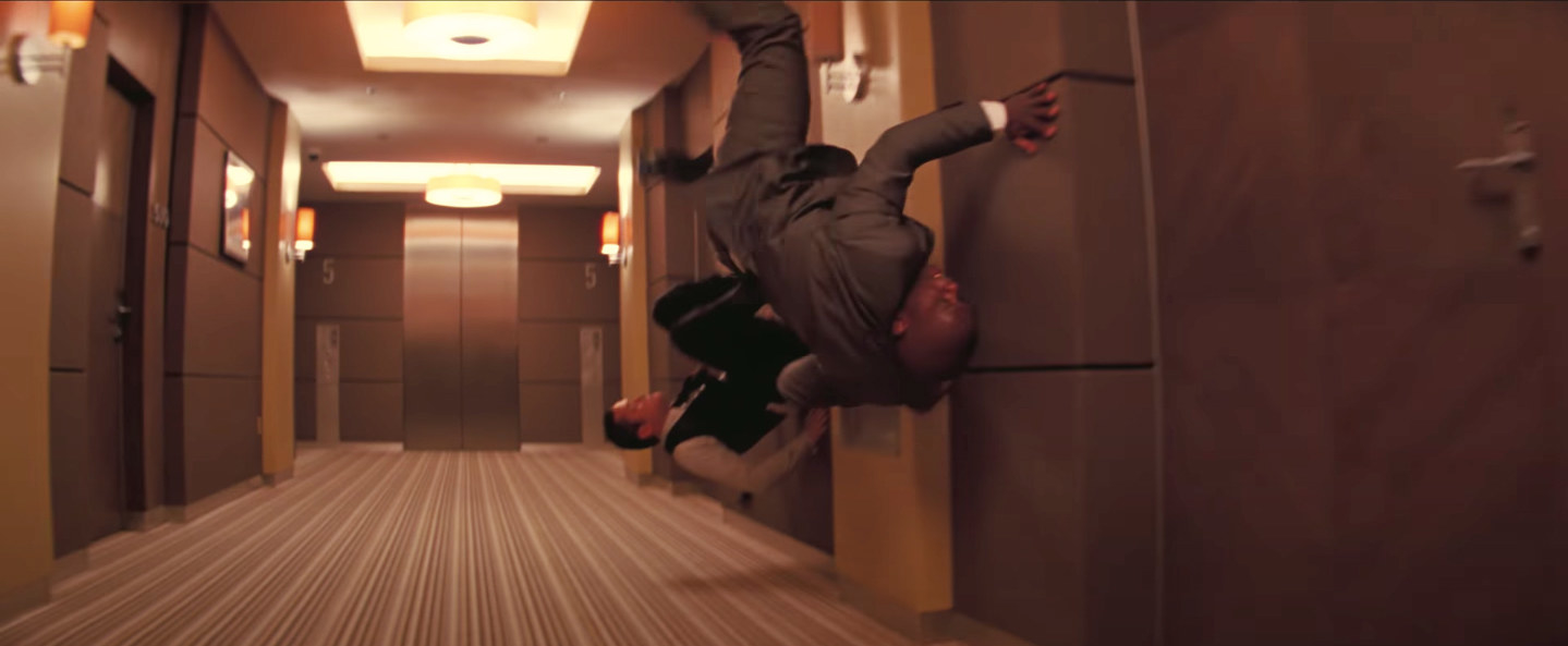 Arthur kicks off the wall as the hallway turns