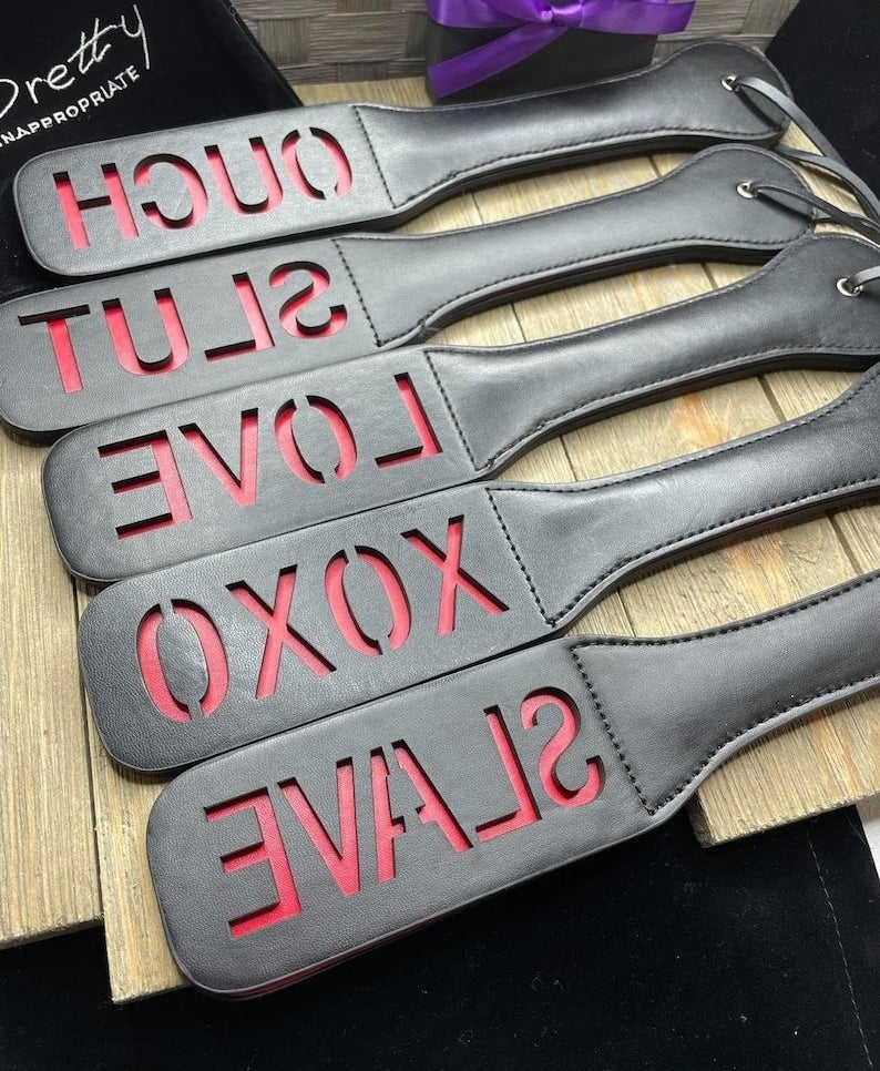 Black and red paddles with cutout words