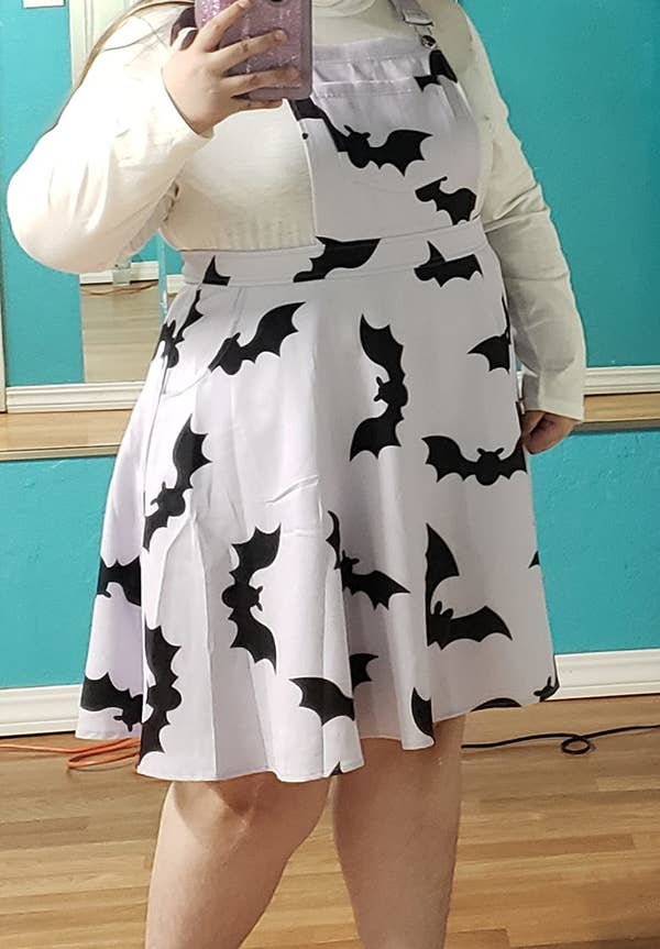 reviewer wearing the lilac bat-covered dress in a size 3X