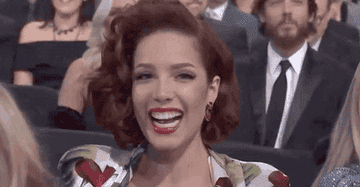 Halsey smiling widely at an awards show