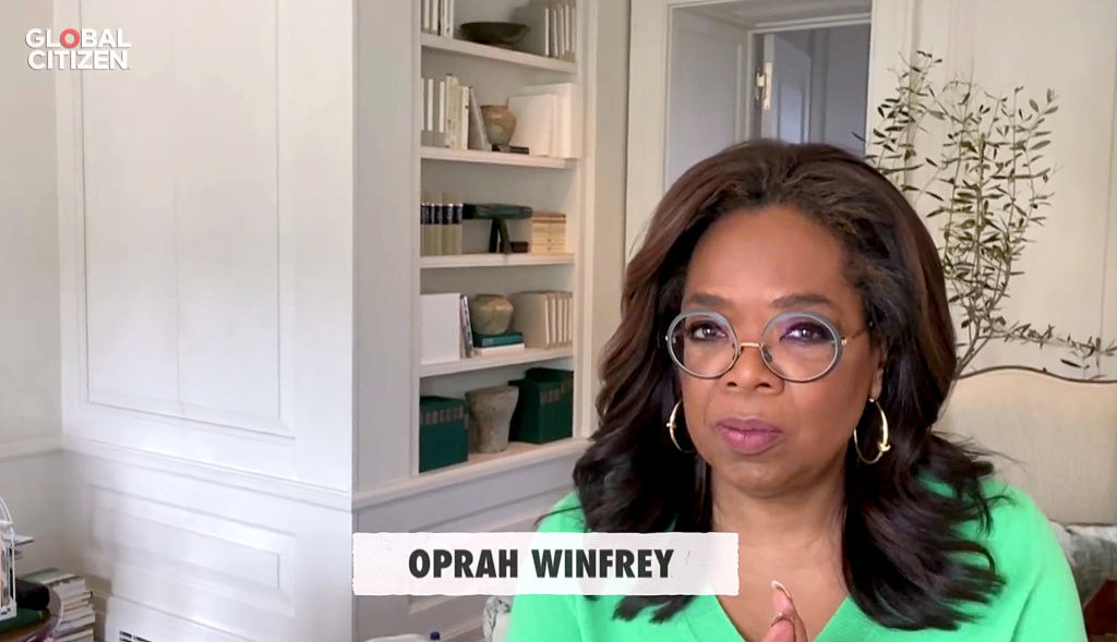 Oprah in green shirt and glasses