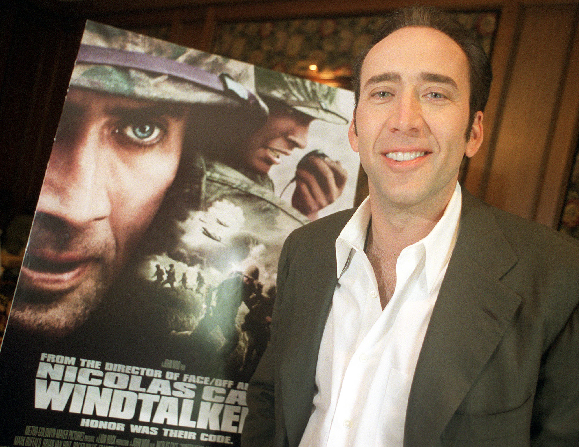 Nicolas Cage next to his own poster