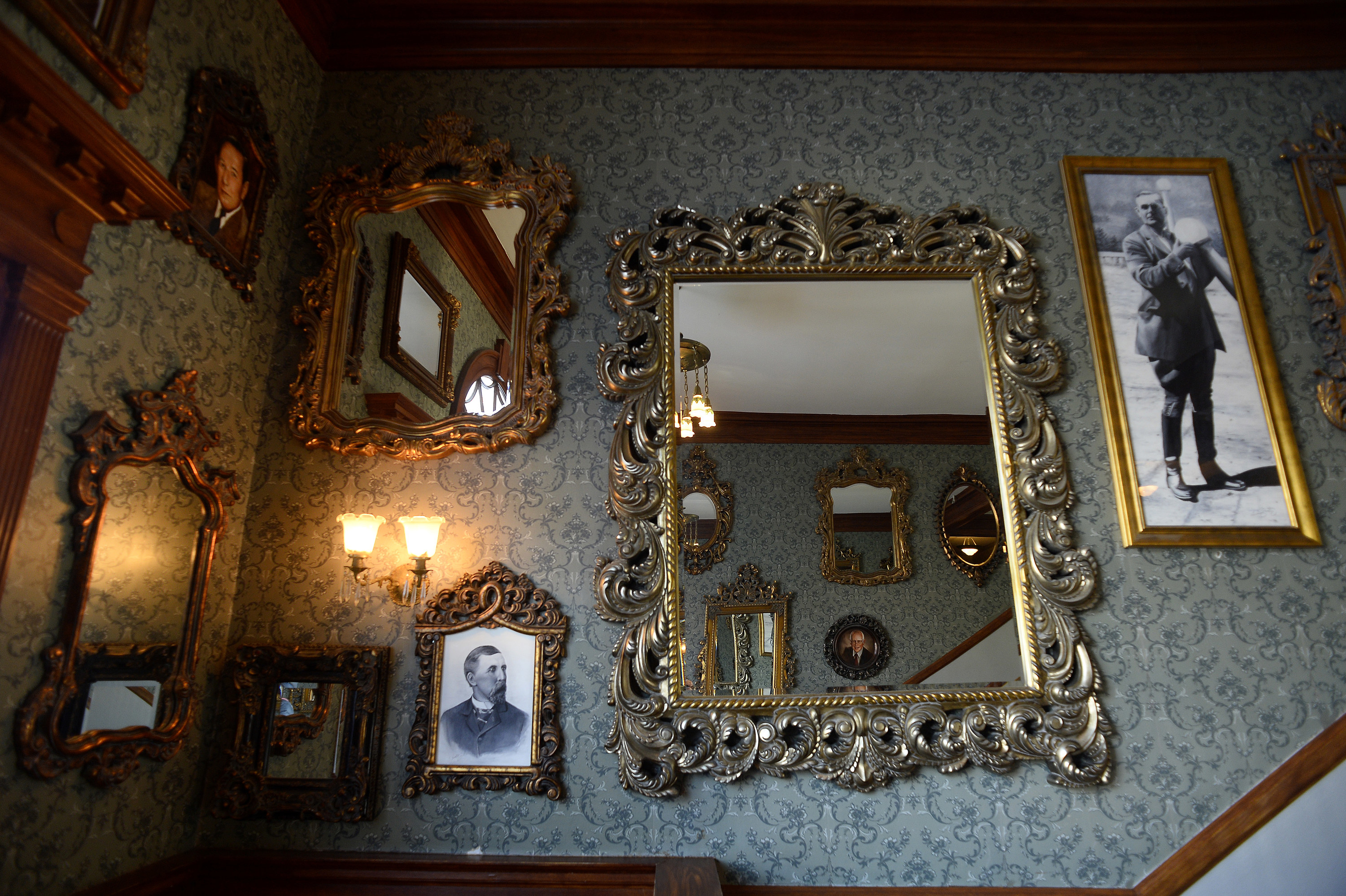 Antique picture frames and mirrors on a wall