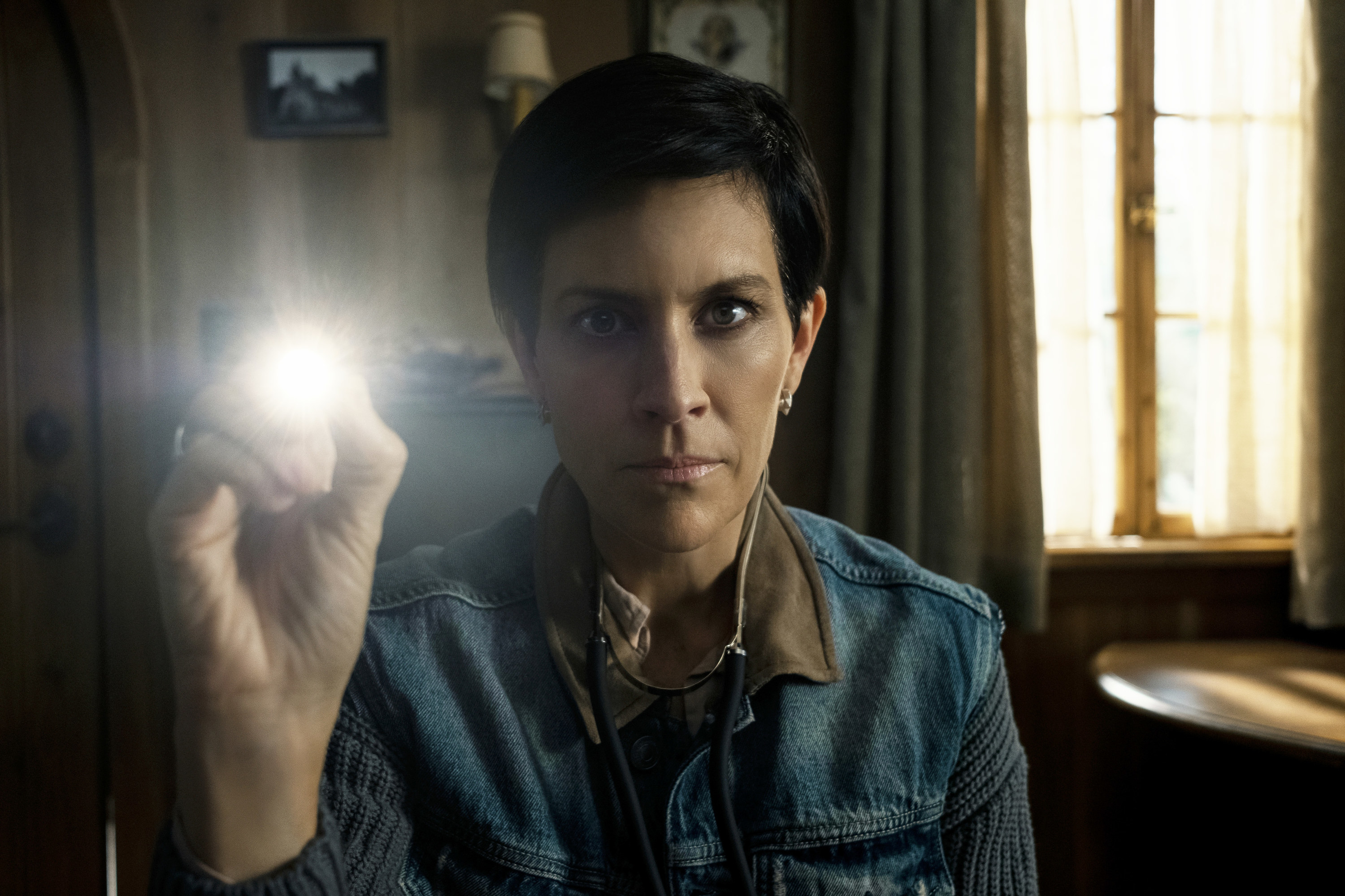 A woman holding a small flashlight
